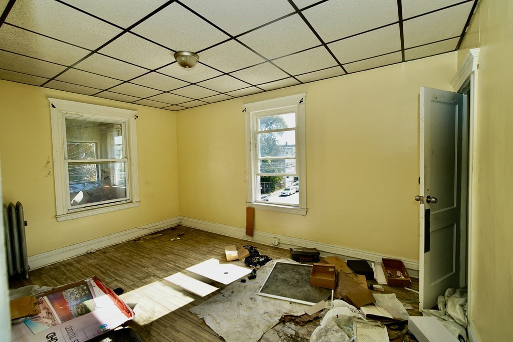 298 Lawrence Street Lawrence, MA 01841 - Photo 34 of 42 a bed room with a bed and a window
