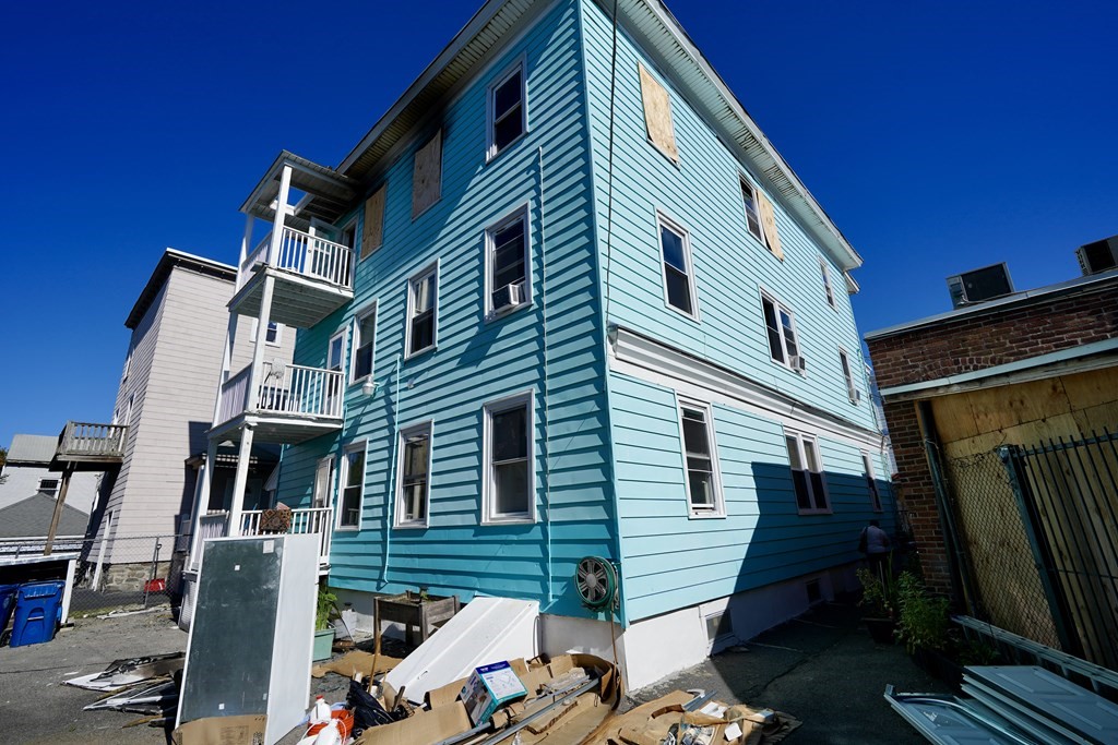 298 Lawrence Street Lawrence, MA 01841 - Photo 7 of 42 a front view of a house with a yard