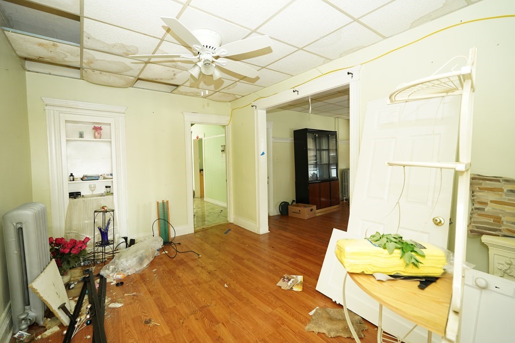 298 Lawrence Street Lawrence, MA 01841 - Photo 8 of 42 a bedroom with a bed and a chandelier