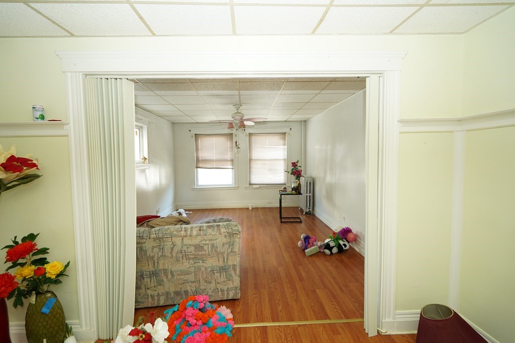 298 Lawrence Street Lawrence, MA 01841 - Photo 10 of 42 a living room with furniture and a potted plant