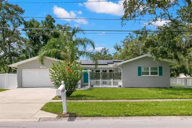 a front view of a house with a garden