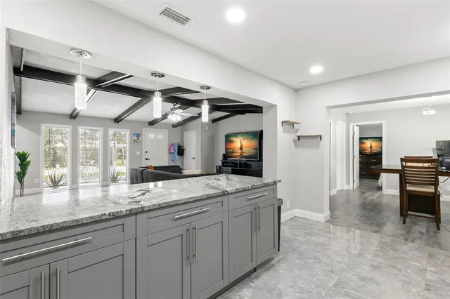 a spacious bathroom with a granite countertop sink mirror and