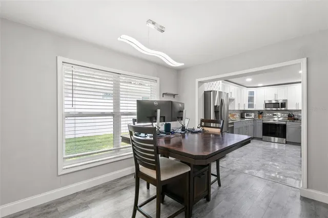 a dining room with furniture and window