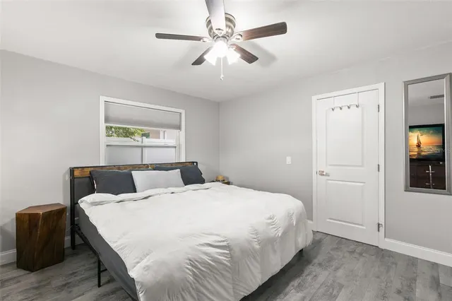 a bedroom with a large bed and a chandelier