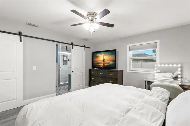 a bedroom with a bed and a flat screen tv