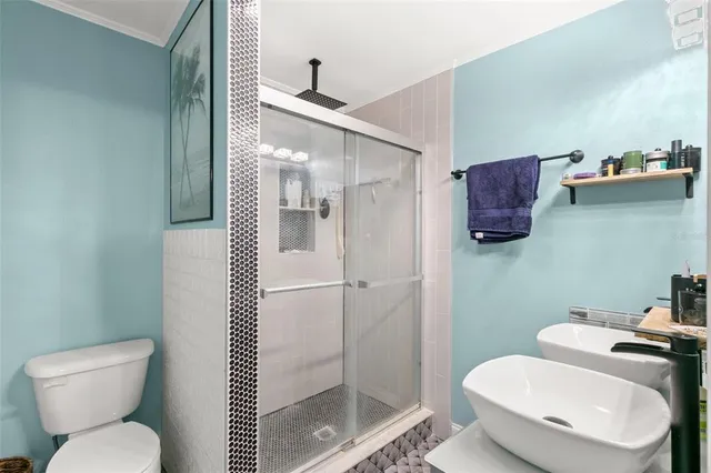 a white toilet sitting next to a bathroom sink