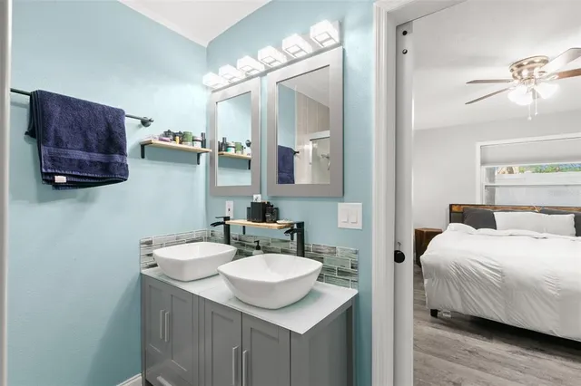 a en suite bathroom with a sink and a mirror