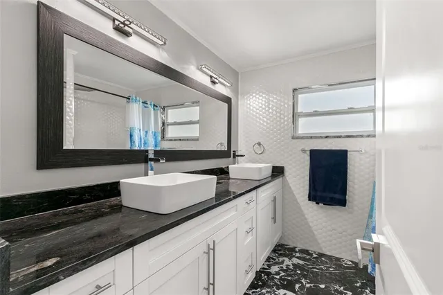 a bathroom with a double vanity sink and mirror