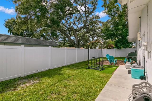a view of a chair and table in the backyard