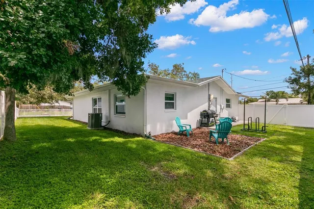 a backyard of a house with table and chairs