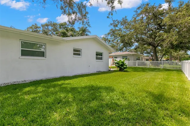 a view of a house with pool and a garden
