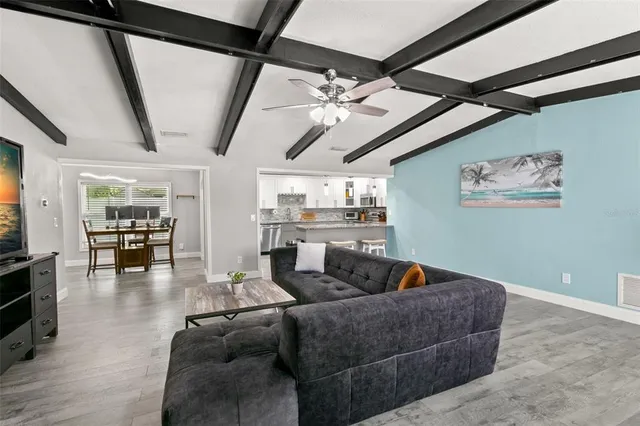 a living room with furniture and wooden floor