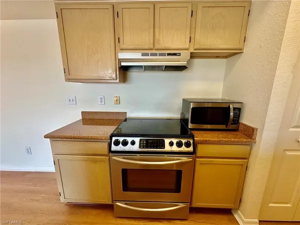 a stove top oven sitting inside of a kitchen