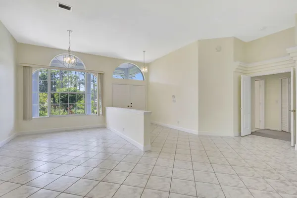 a view of a kitchen with kitchen island a sink stainless steel appliances and cabinets