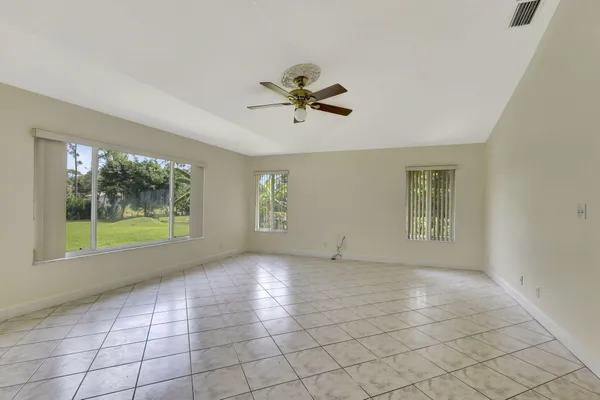 a spacious bedroom with a bed and a flat screen television