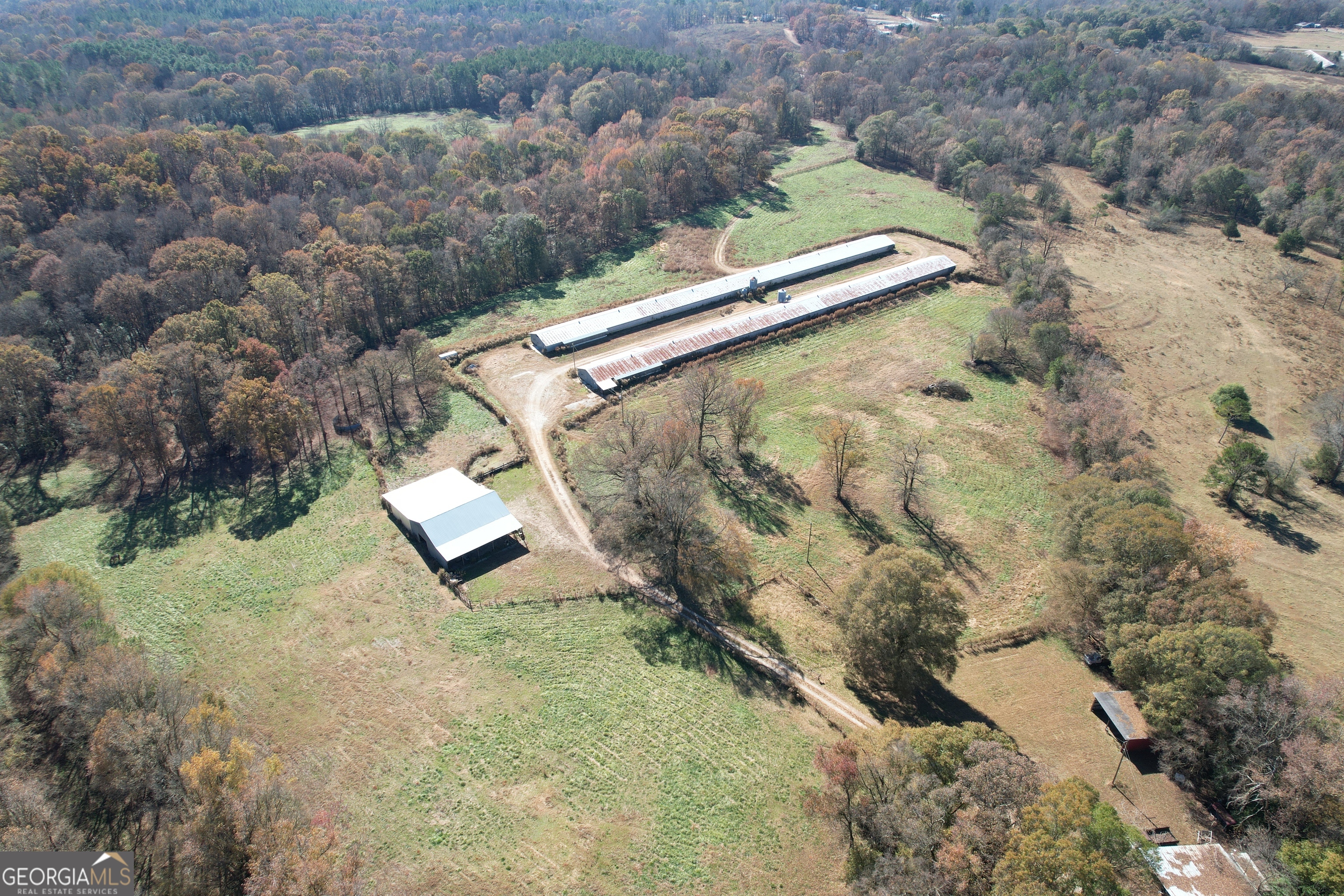 an aerial view of a house with a yard and lake