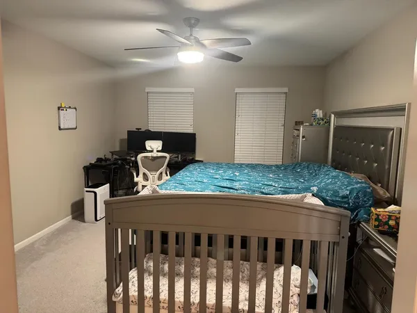 a bedroom with a bed and a chandelier