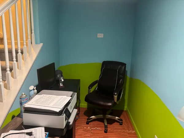 a living room with furniture and a piano