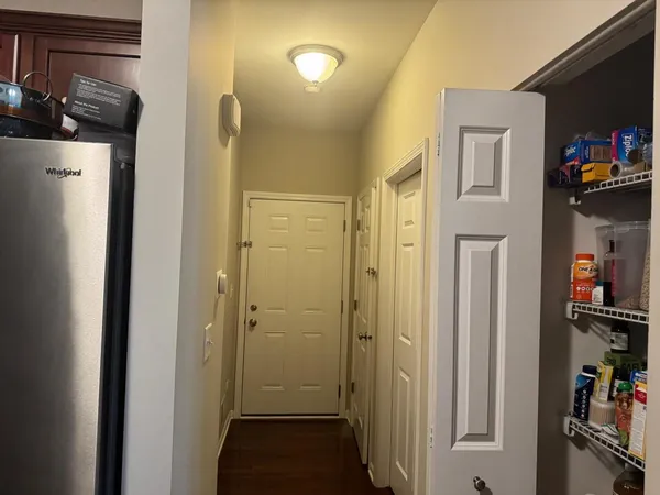 a view of a storage & utility room with a refrigerator