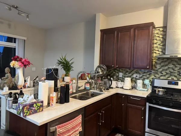 a kitchen with a sink cabinets and stove
