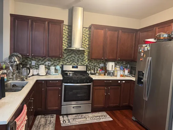 a kitchen with a sink stove and refrigerator