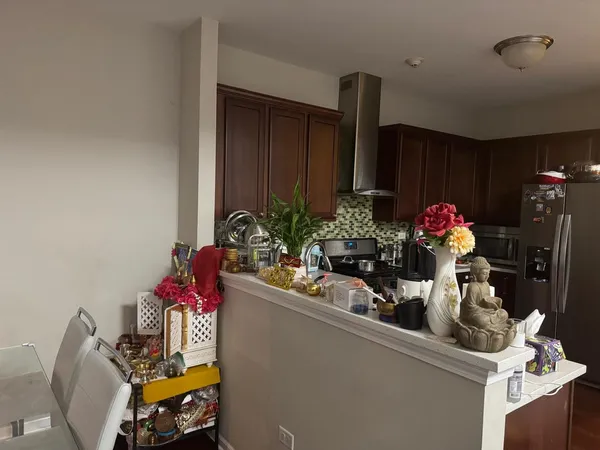 a view of a room with kitchen furniture and potted plants