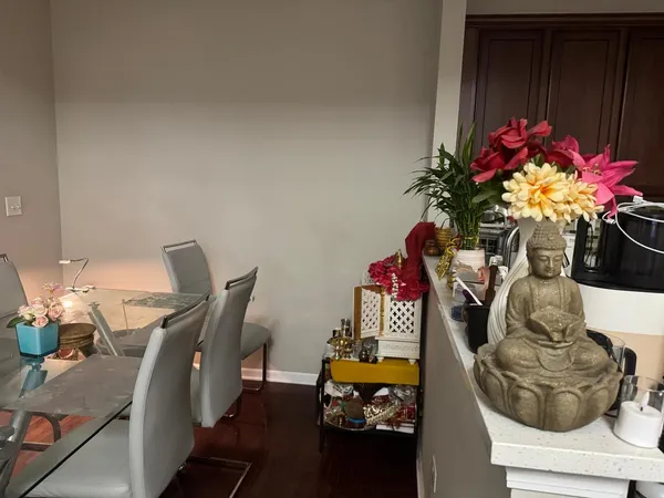 a dining room with furniture and a potted plant