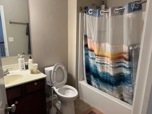 a bathroom with a sink toilet and shower