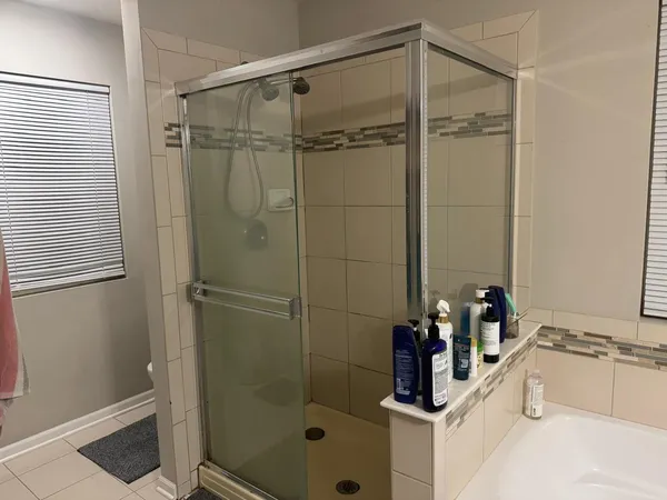 a bathroom with a shower and a sink