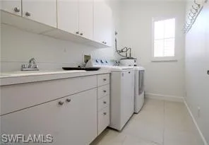 a kitchen with appliances a sink and cabinets