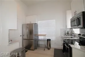 a kitchen with a refrigerator stove and a sink