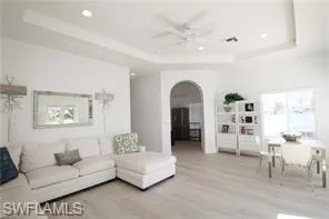 a living room with furniture and a painting on the wall