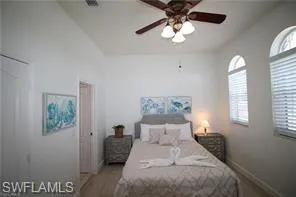 a bedroom with a bed and a chandelier