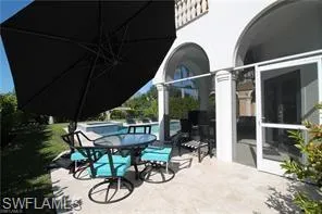 a view of patio with chairs and table in patio