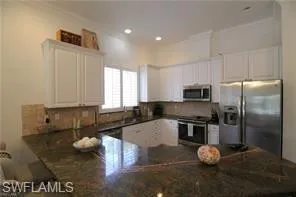 a kitchen with a sink appliances and cabinets