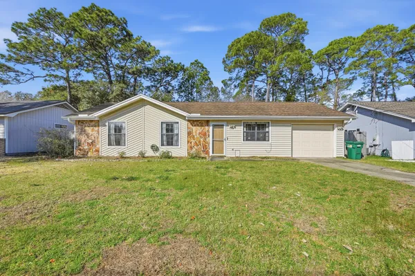 a view of a house with a backyard