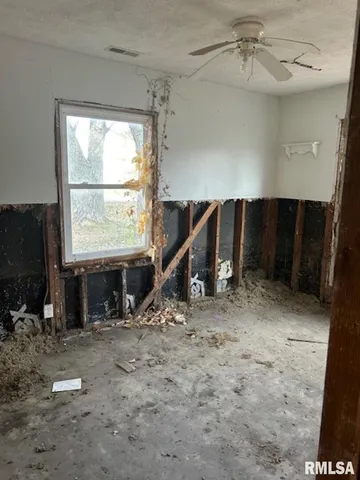 a view of a livingroom with furniture and a window