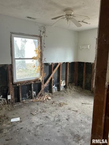 a view of a livingroom with furniture and a window