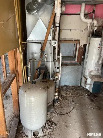 a room with water heater and wooden floor