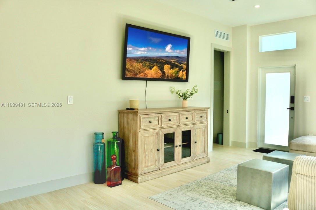 2975 Southwest 15th Street Miami, FL 33145 - Photo 16 of 27 a living room with a flat screen tv and a fireplace