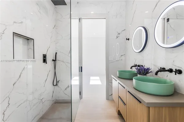 a bathroom with a double vanity sink and a mirror