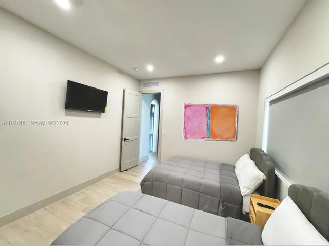 a spacious bathroom with a toilet sink and mirror