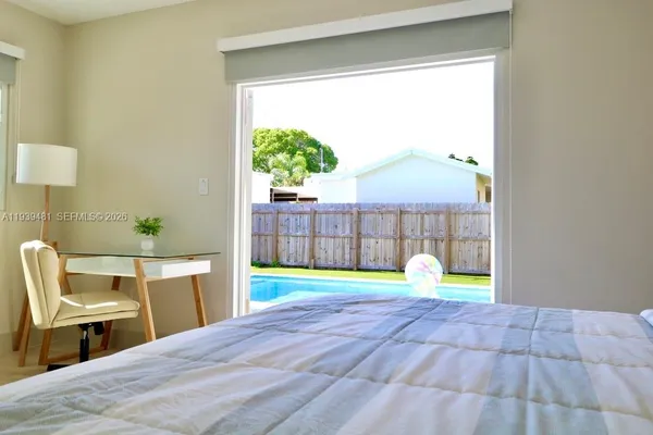a bed room with a bed and a chair
