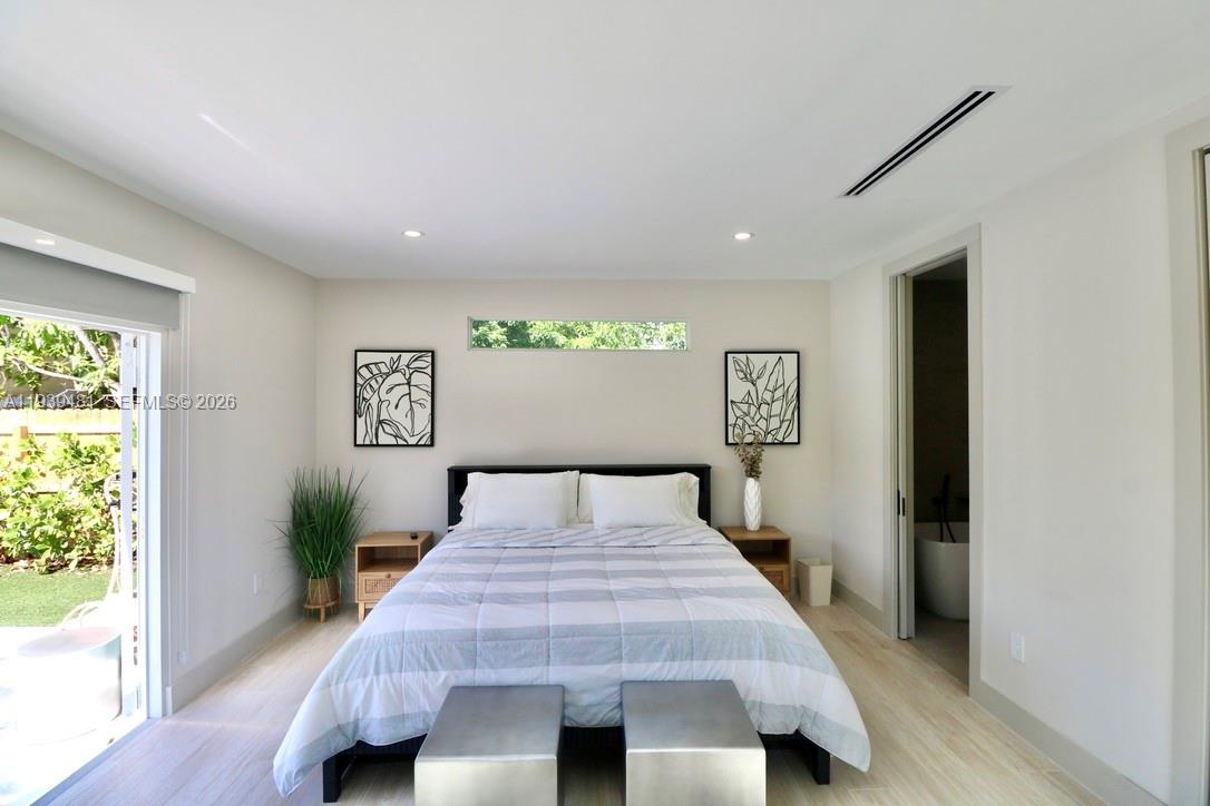 2975 Southwest 15th Street Miami, FL 33145 - Photo 10 of 27 a bedroom with a bed and a window