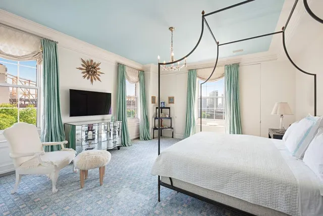 a bedroom with a bed couch and a flat screen tv