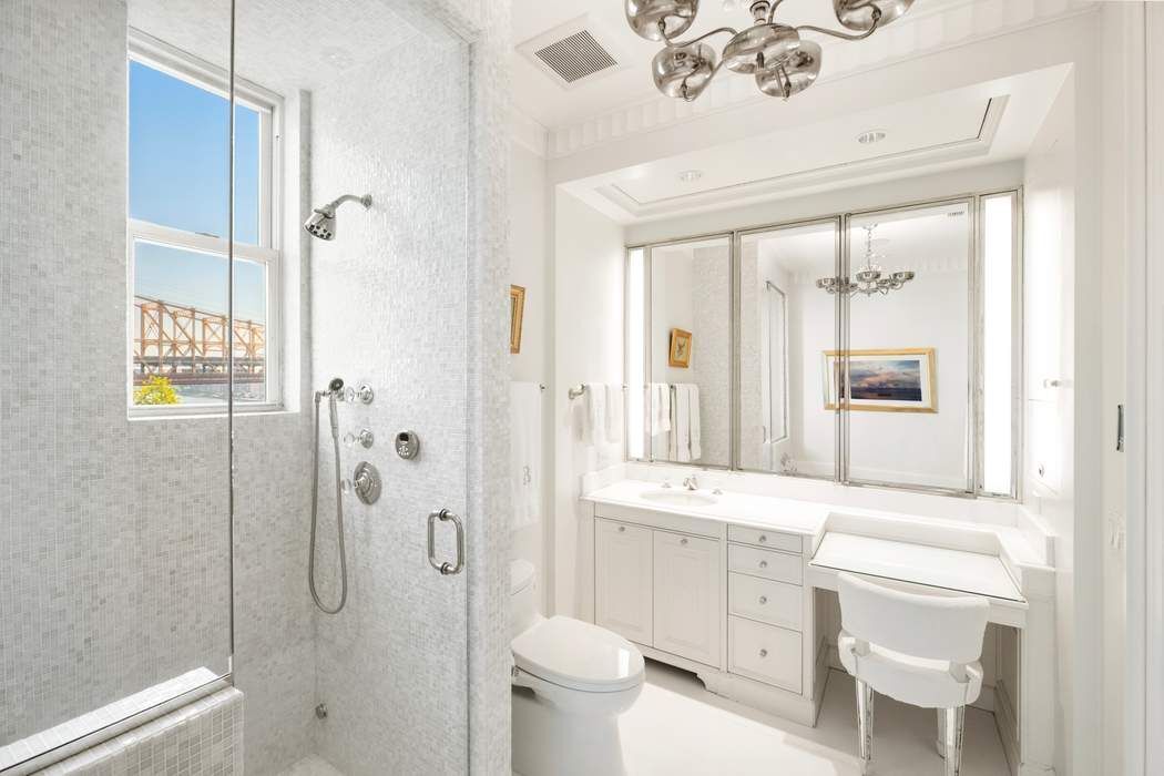 1 Sutton Place South, Unit 7C Manhattan, NY 10022 - Photo 13 of 16 a bathroom with a granite countertop sink toilet and shower