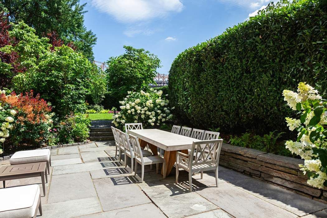 1 Sutton Place South, Unit 7C Manhattan, NY 10022 - Photo 15 of 16 a patio with table and chairs and potted plants