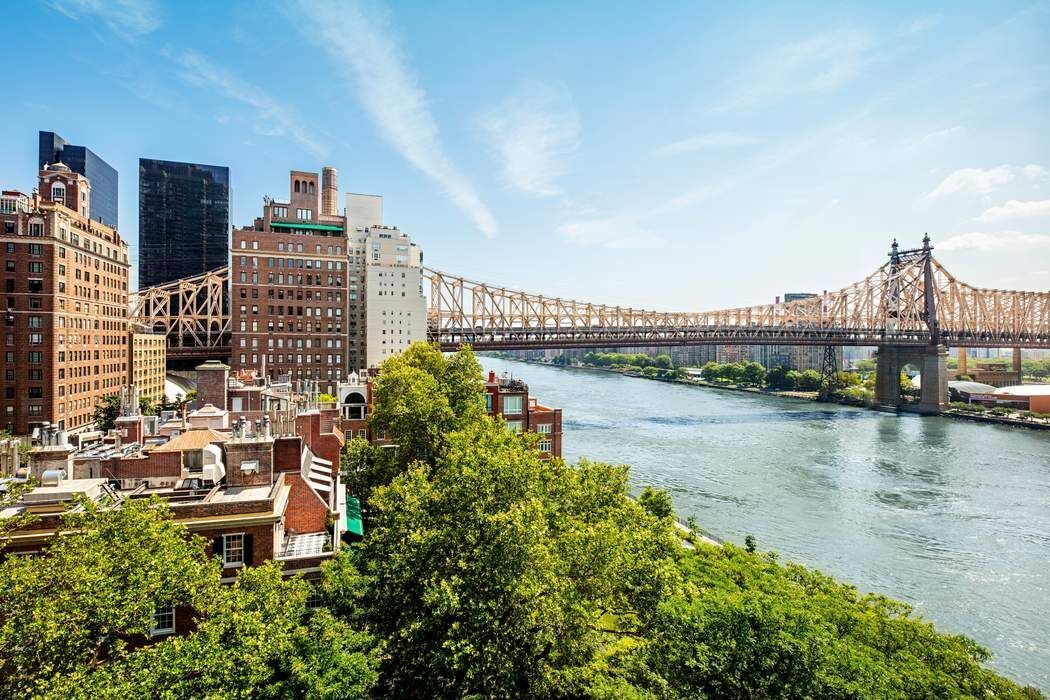 1 Sutton Place South, Unit 7C Manhattan, NY 10022 - Photo 7 of 16 a view of a lake with a city skyline in the background