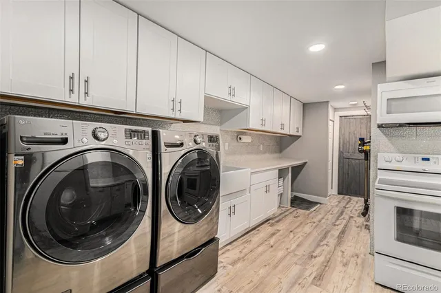 a kitchen with stainless steel appliances a stove a refrigerator and a microwave