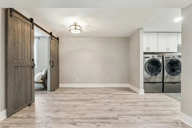 a view of kitchen and hall with wooden floor